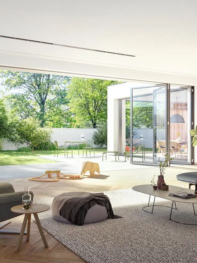 Ambiente living con porte scorrevoli a libro Schüco completamente aperte verso il giardino